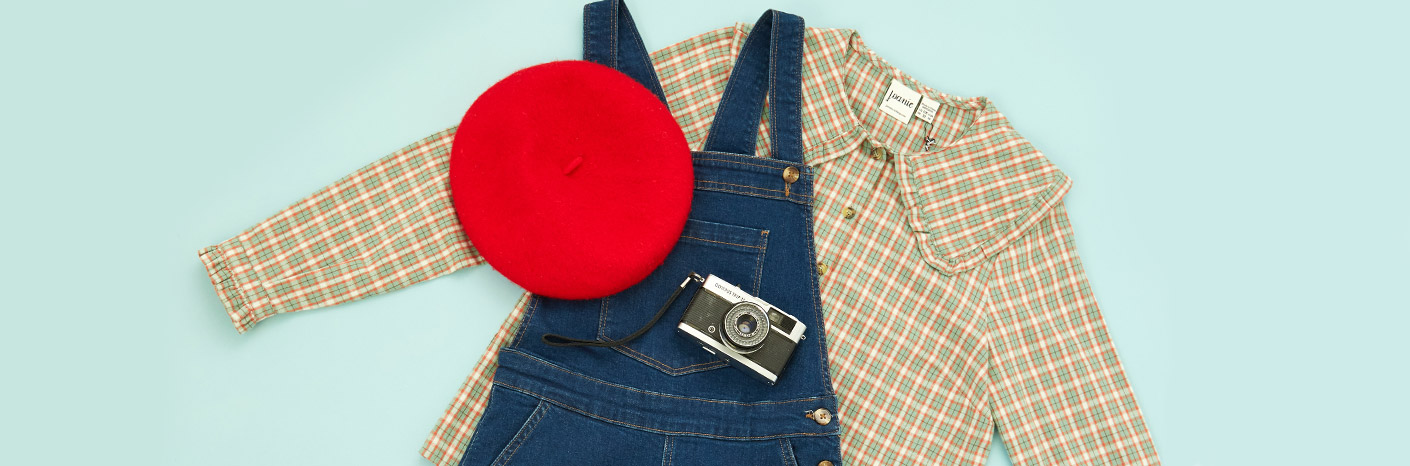 Flatlay of Bleecker Dungarees, Venetia Blouse, and a red beret